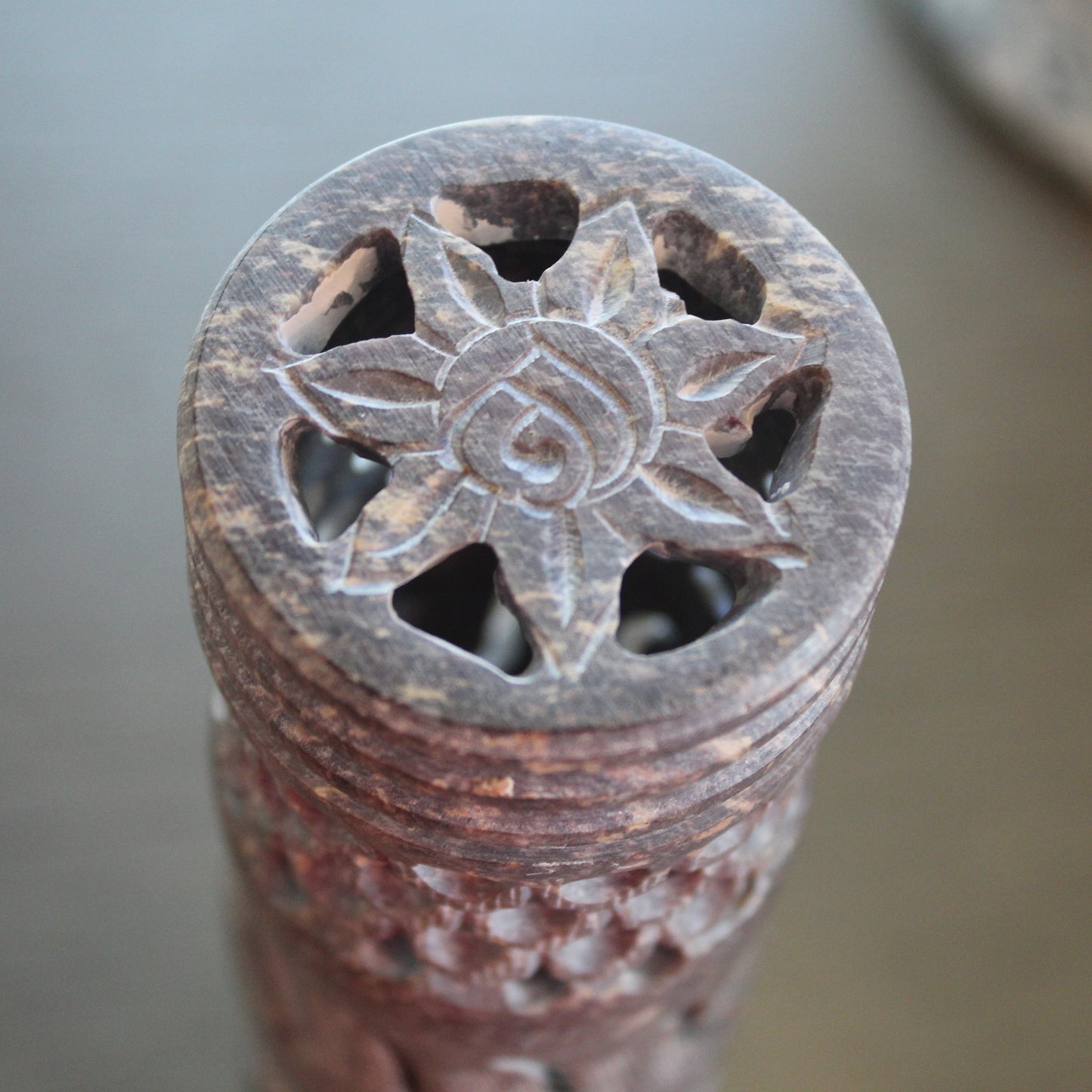 Decorative stone object with star-like design on a blurred background