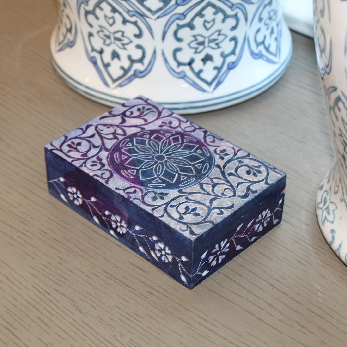 Decorative box with intricate patterns on a wooden surface