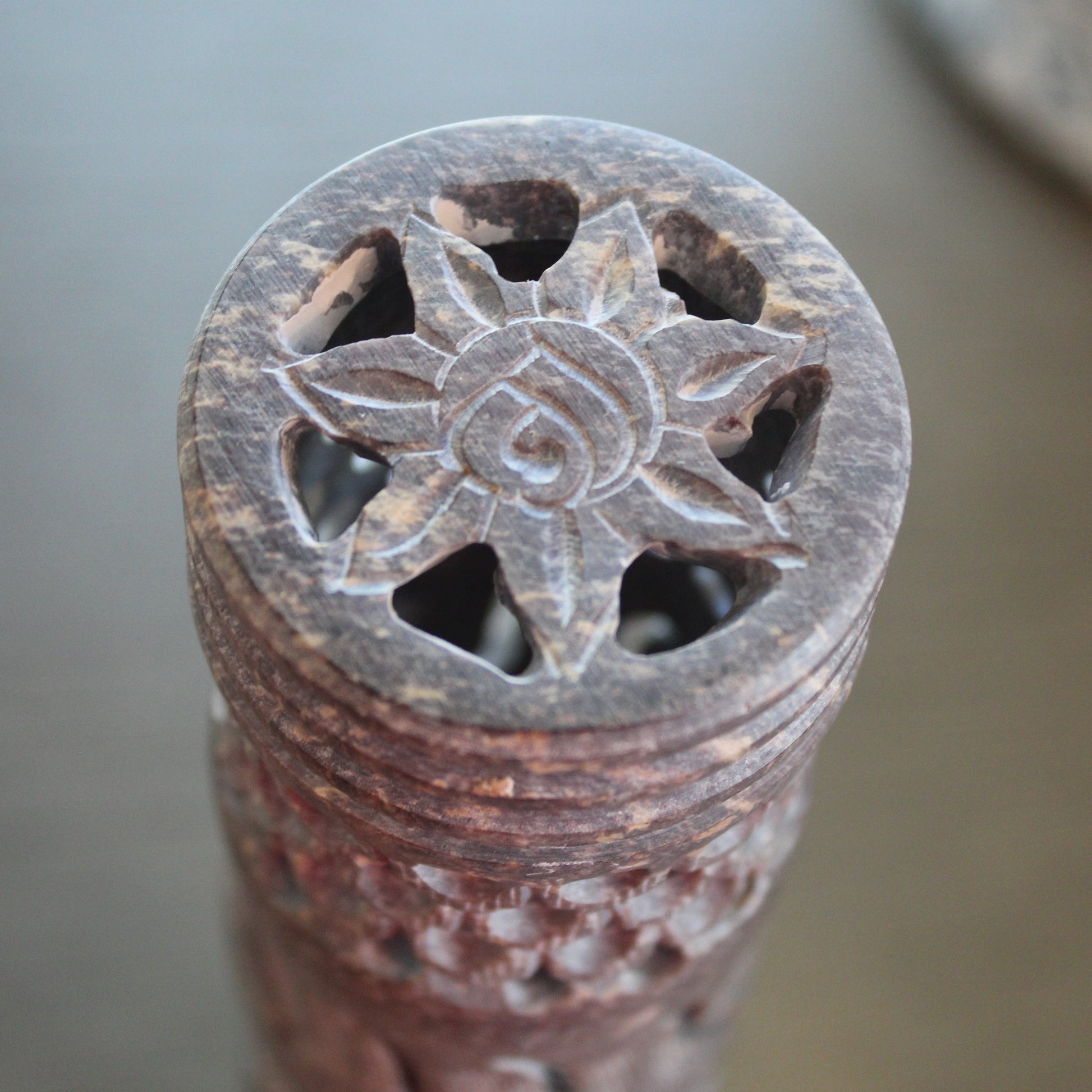 Decorative stone object with star-like design on a blurred background