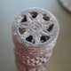 Decorative stone object with star-like design on a blurred background