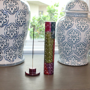 Two decorative vases with intricate patterns on a wooden surface.