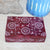 Decorative wooden box with floral patterns on a textured surface