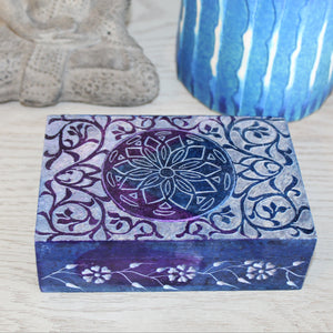 Decorative box with floral patterns on a textured surface