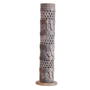 Decorative cylindrical object with intricate patterns on a white background