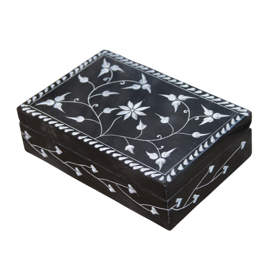 Decorative black box with white floral patterns on a white background